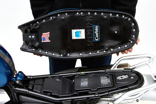 a person holding Dual seat showing the back side, MPN printed and mounting brackets pre-installed