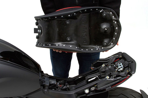 a person holding Gunfighter seat showing the back side, MPN printed and mounting brackets pre-installed
