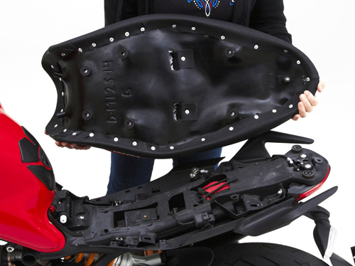 a person holding Gunfighter seat showing the rear side, MPN printed and mounting brackets pre-installed