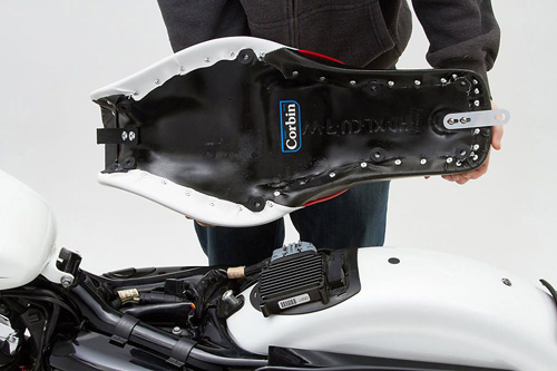 a person holding Widowmaker seat showing the rear side, MPN printed and mounting brackets pre-installed