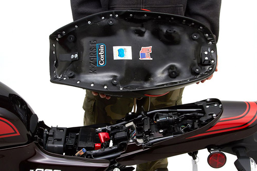 a person holding Gunfighter seat showing the MPN printed and mounting brackets pre-installed