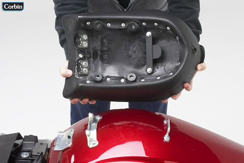 a person holding pillion seat showing the rear side mounting brackets pre-installed