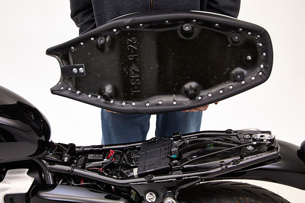 a person holding Classic Gunfighter seat showing the rear side MPN printed and mounting brackets pre-installed