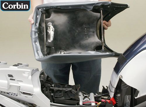 a person is hodling front seat showing adjustable mounting brackets installed