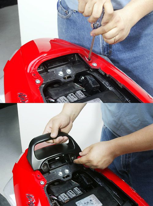 a person is opening  the mounting brackets with a screw driver where you need to attach the seat