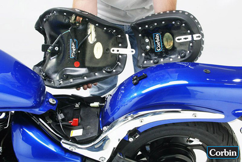 a person is holding solo and pillion seat showing rear side with mounting bracket pre-installed