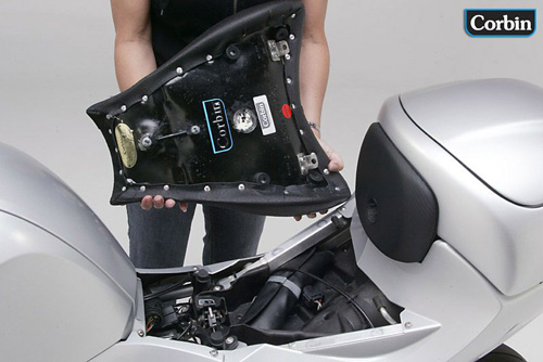 a person is holding front seat showing rear side with MPN printed and mounting brackets pre-installed