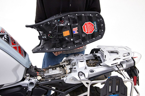 a person is holding Rally seat showing MPN printed at rear side and mounting brackets preinstalled